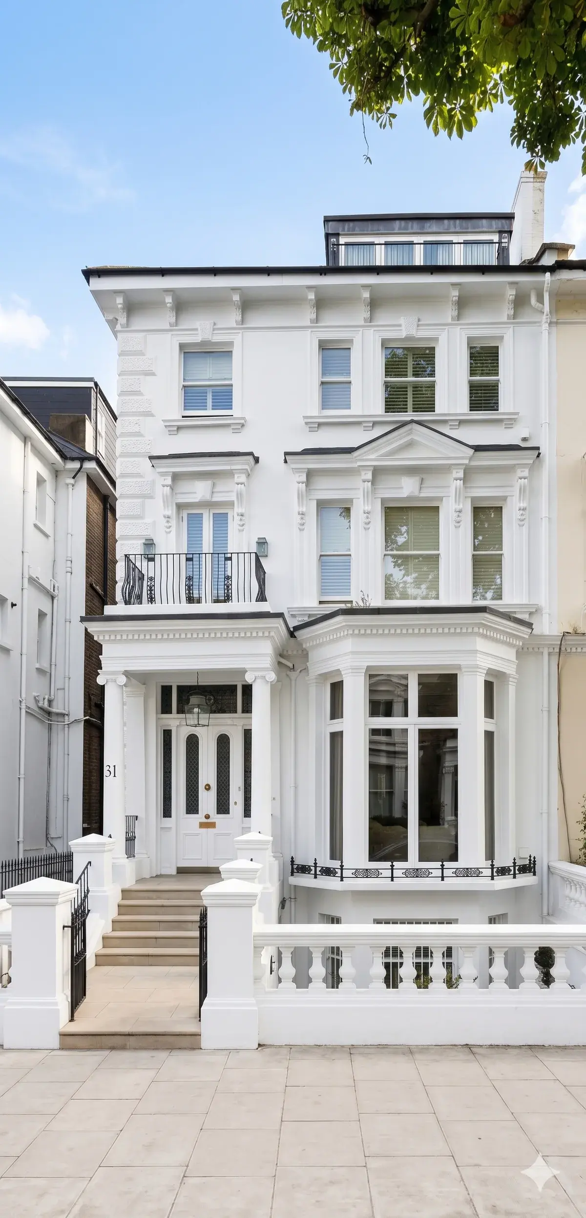 White stucco house exterior with bay windows and a dormer, refurbished by Hampstead Renovations